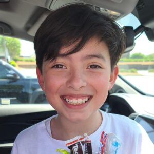 Smiling young boy post orthodontic braces treatment